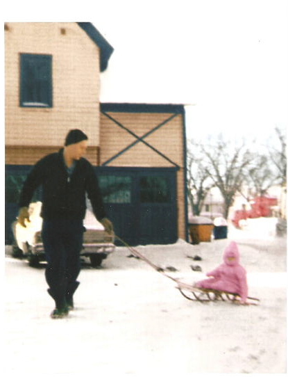 Daddy and me (1 year) "sledding" in the backyard